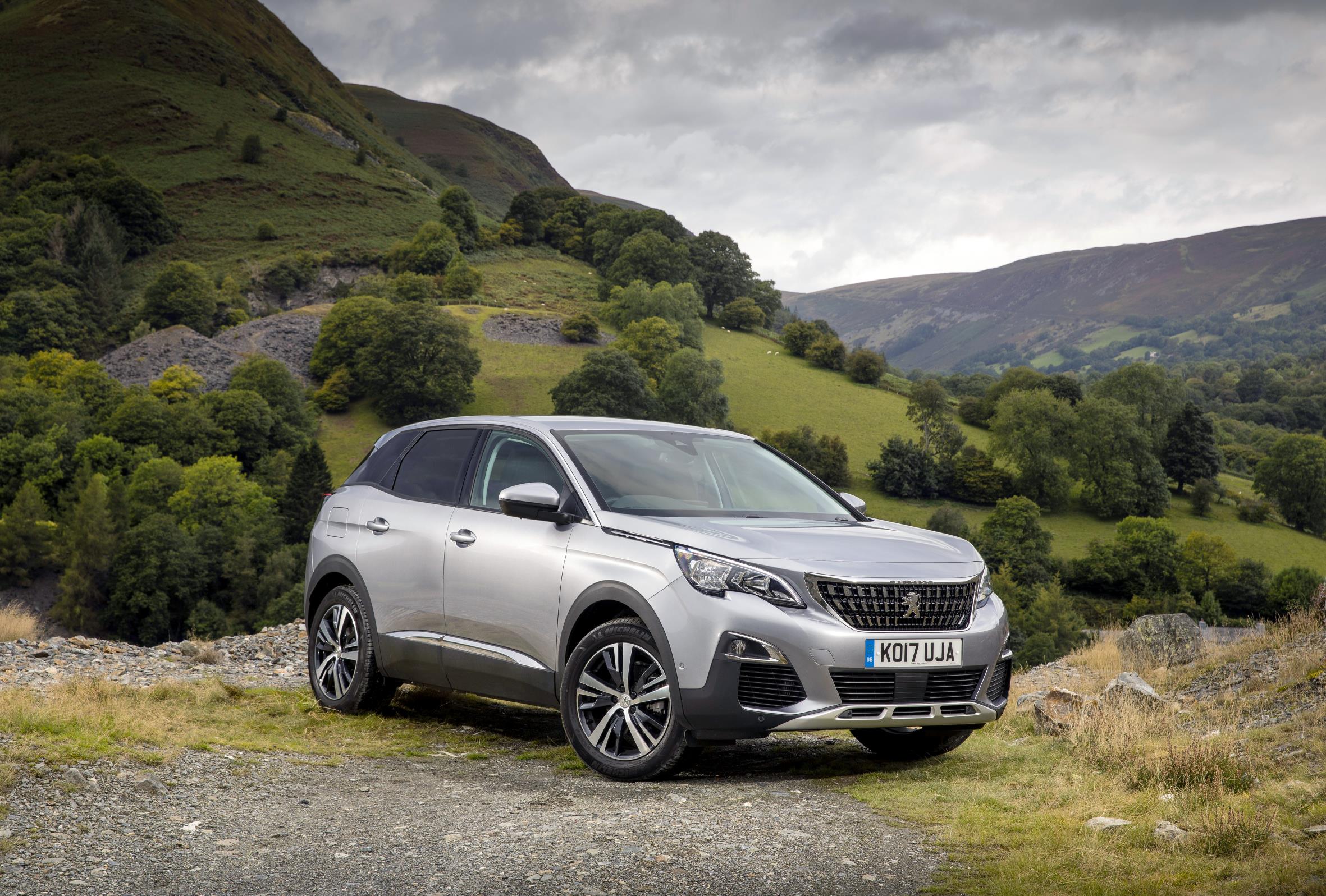 SIlver Peugeot 3008 SUV parked with a dramatic backdrop